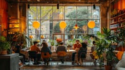 Cozy cafe interior with people sitting at tables, orange hanging lamps, and large windows showing trees outside